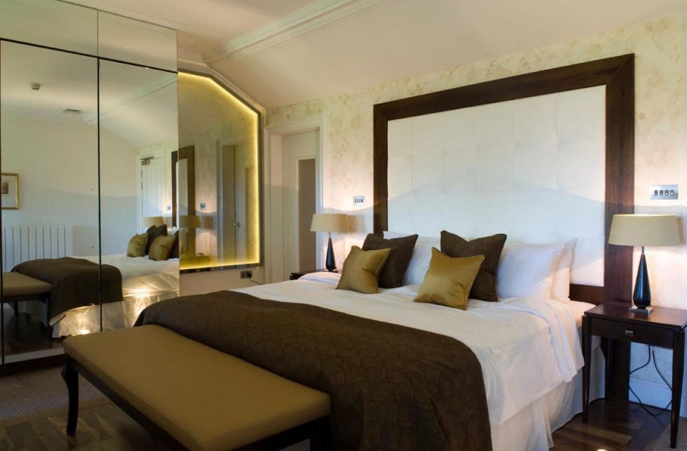 a bedroom with a large mirror