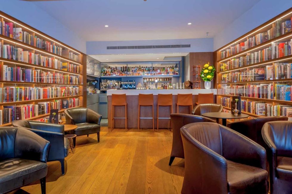 a library with bookshelves and a bar