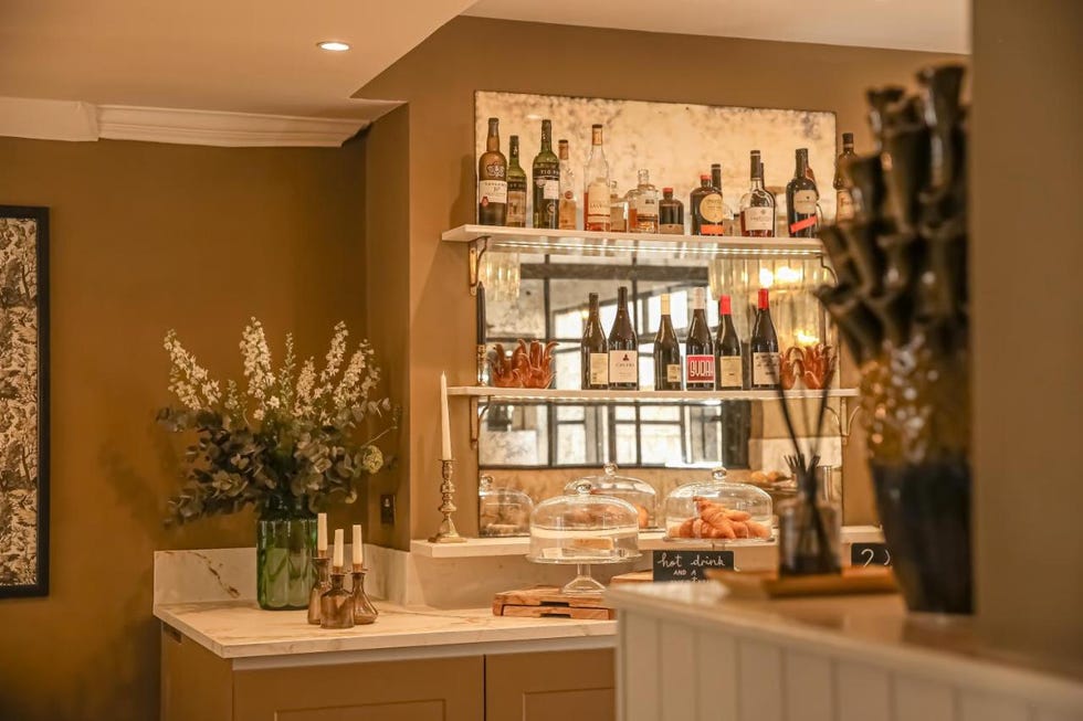 a kitchen with shelves full of wine