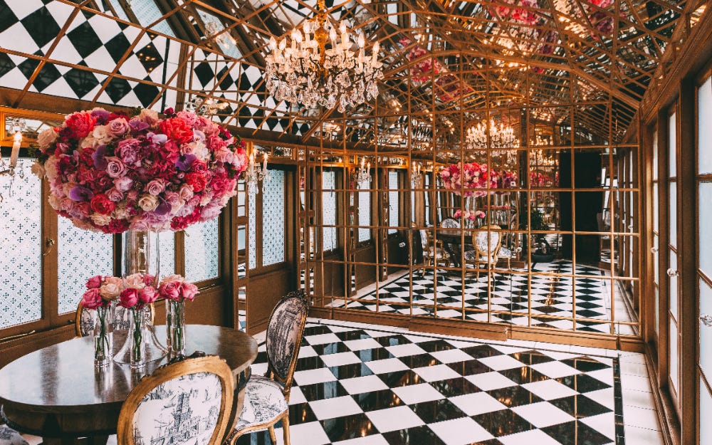mirror room with flowers and chequerboard flooring