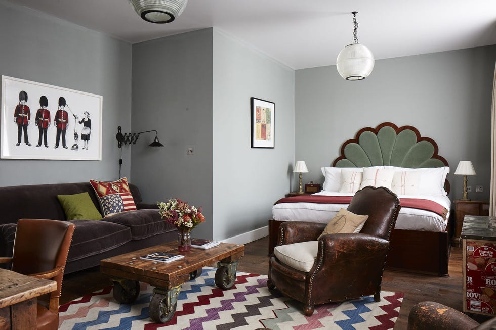 double bed and seating area in a grey bedroom