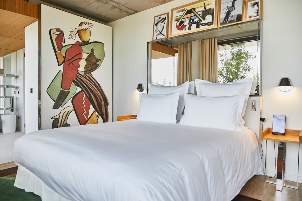 a bed in a room with modern art at villa m