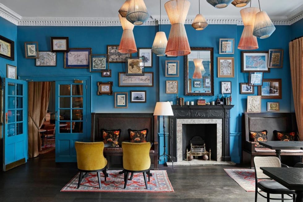 a lounge with a fireplace and chairs