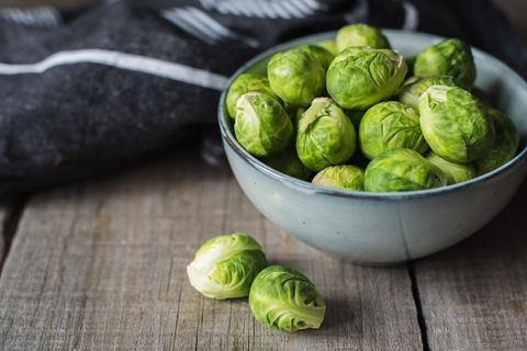 bowl of brussels sprouts and napkin on a rustic wooden table