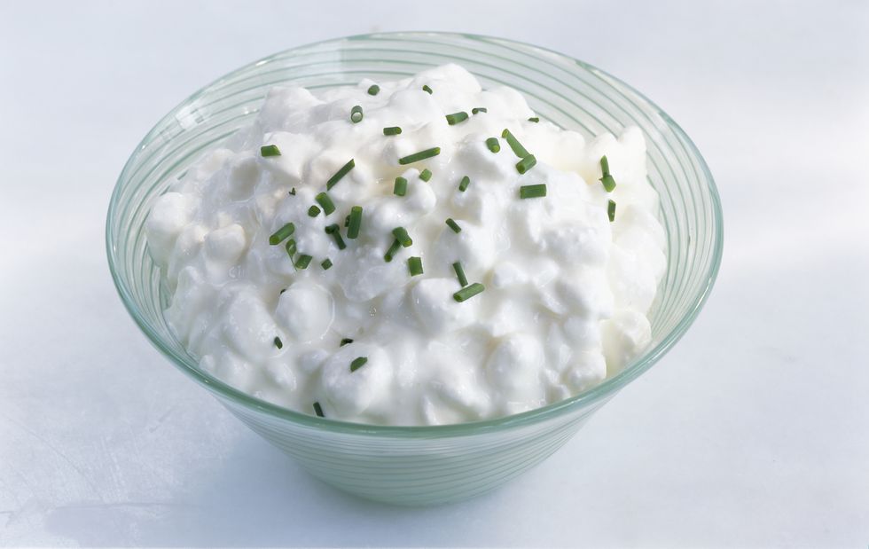 Bowl of cottage cheese with chives, close-up