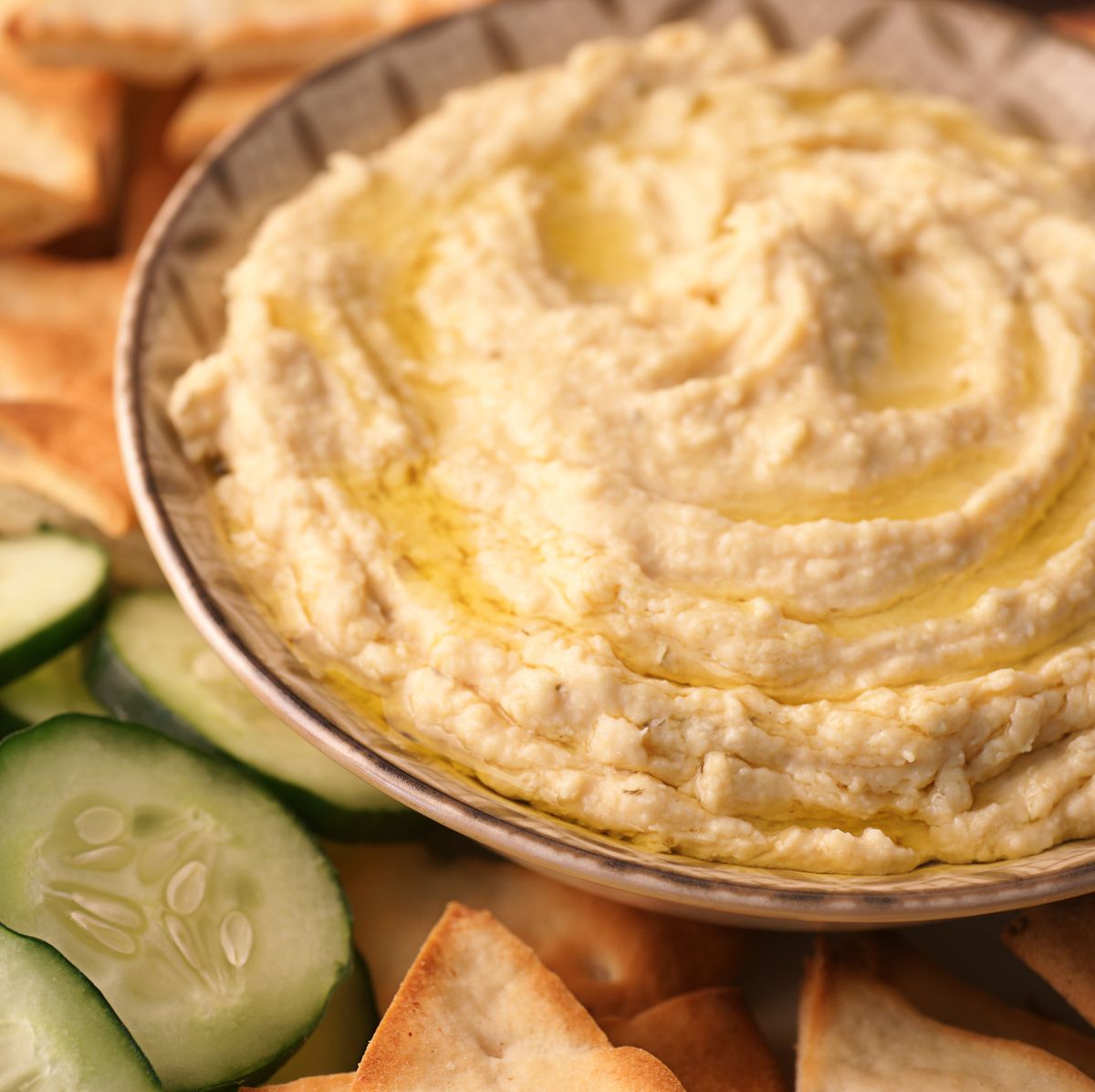 a bowl of fresh hummus and cucumbers