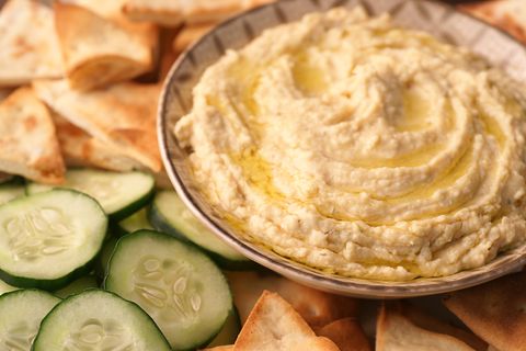 a bowl of fresh hummus and cucumbers