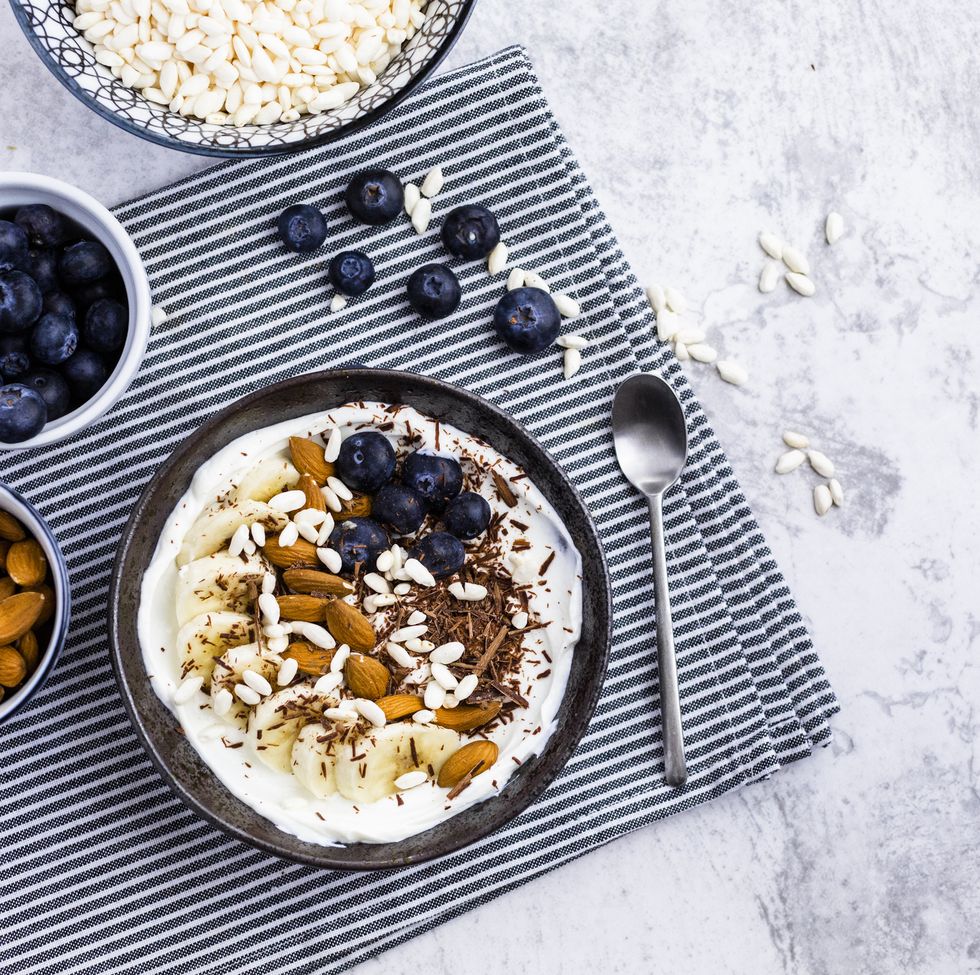 bowl of fresh muesli, blueberries and almonds seen from above