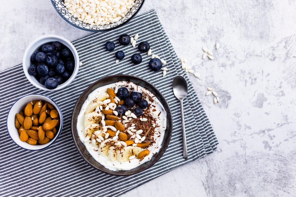 bowl of fresh muesli, blueberries and almonds seen from above