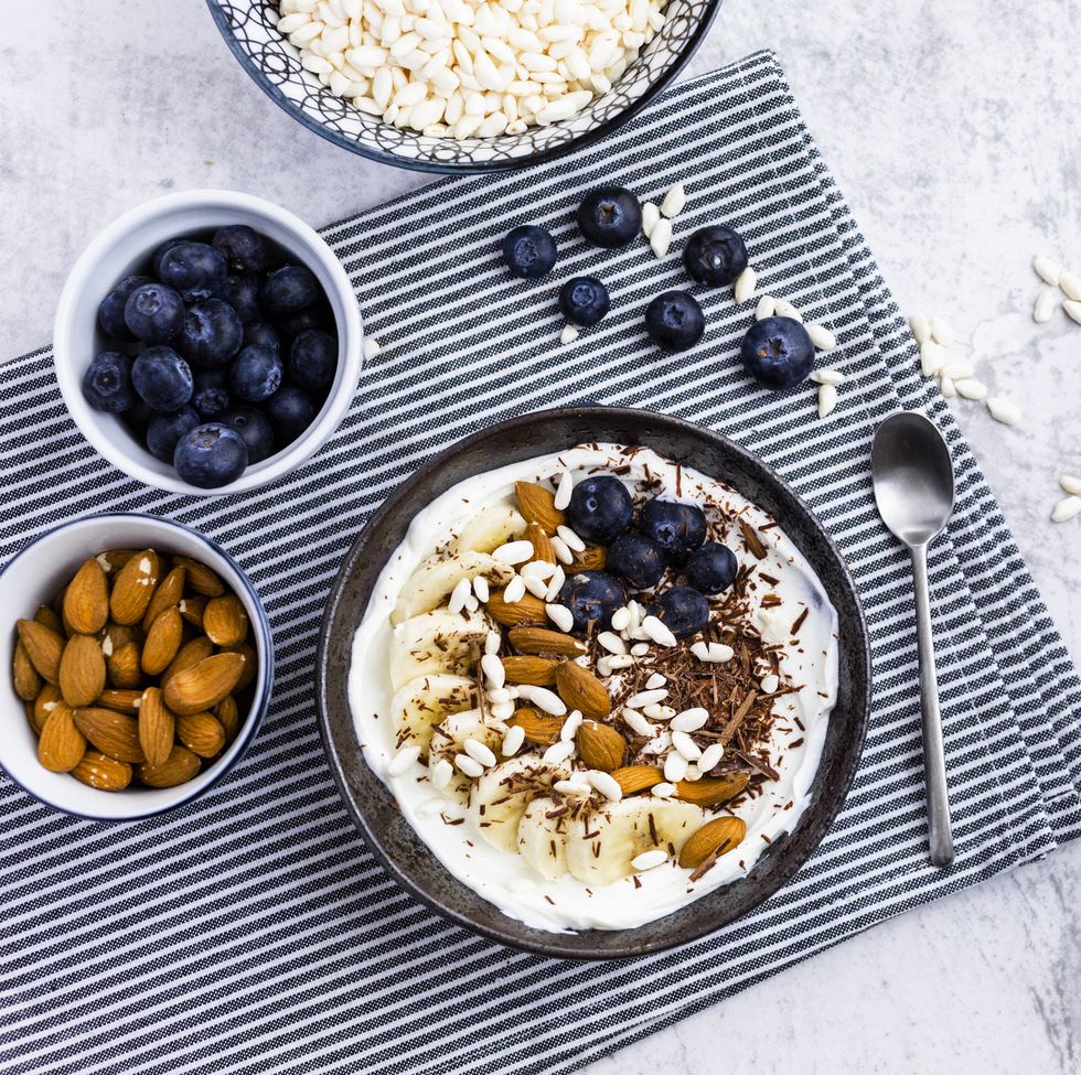 bowl of fresh muesli, blueberries and almonds seen from above