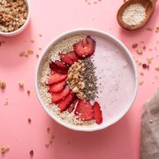 a bowl of healthy and delicious strawberry smoothie with grains and fresh fruit
