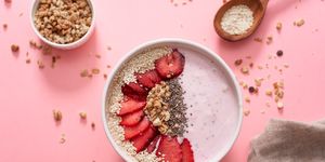 a bowl of healthy and delicious strawberry smoothie with grains and fresh fruit