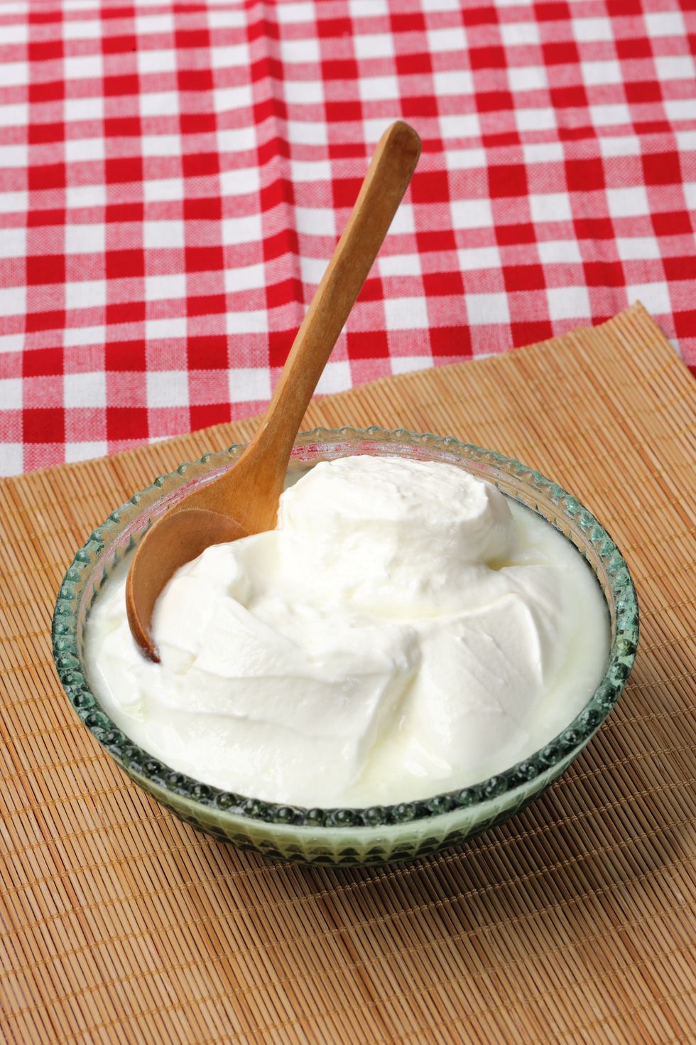 bowl of homemade yogurt with wooden spoon