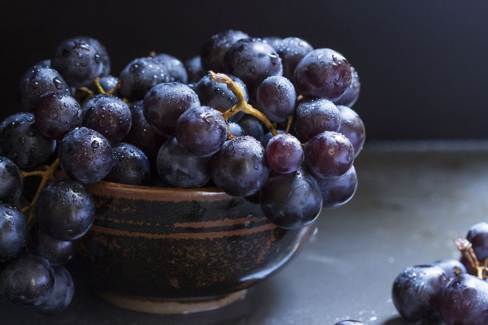 bowl of juicy ripe black grapes
