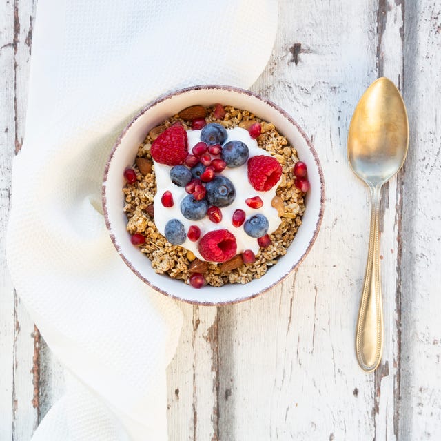 bowl of muesli with greek yogurt, popped quinoa, raspberries, blueberries and pomegranate seed