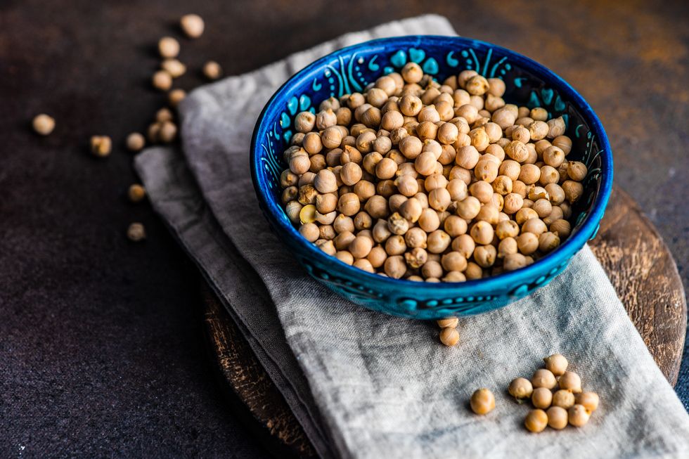 bowl of raw chickpeas on a chopping board and napkin