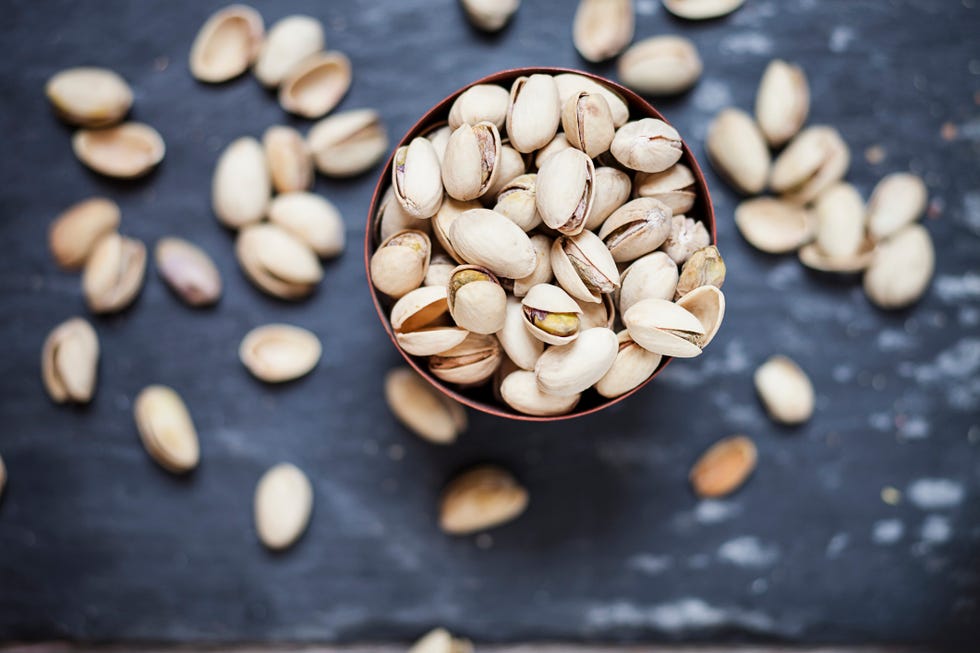 bowl of roasted and salted pistachios on slate