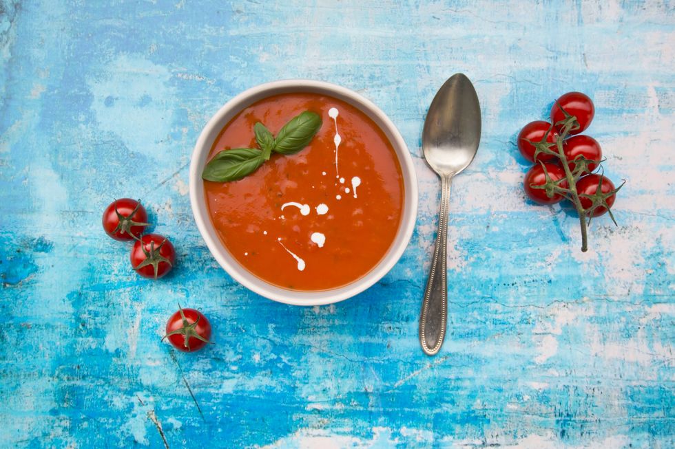 bowl of tomato soup on blue surface