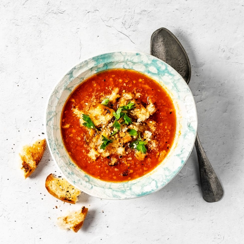 bowl of tomato soup on white background