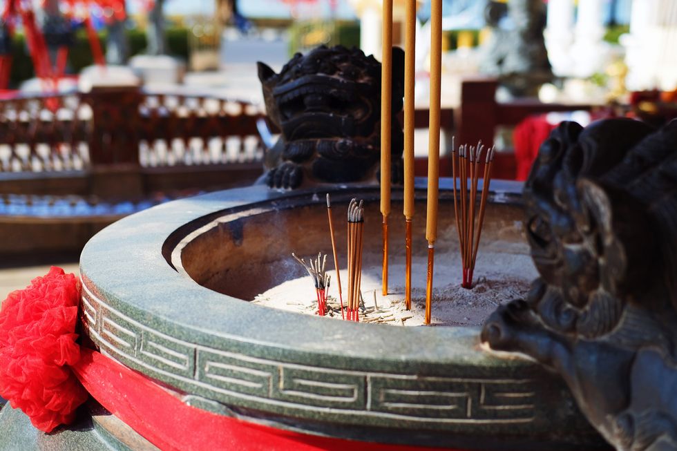 a bowl with figures of fu dogs for incense sticks in a chinese temple