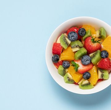 bowl with fruit salad on blue background