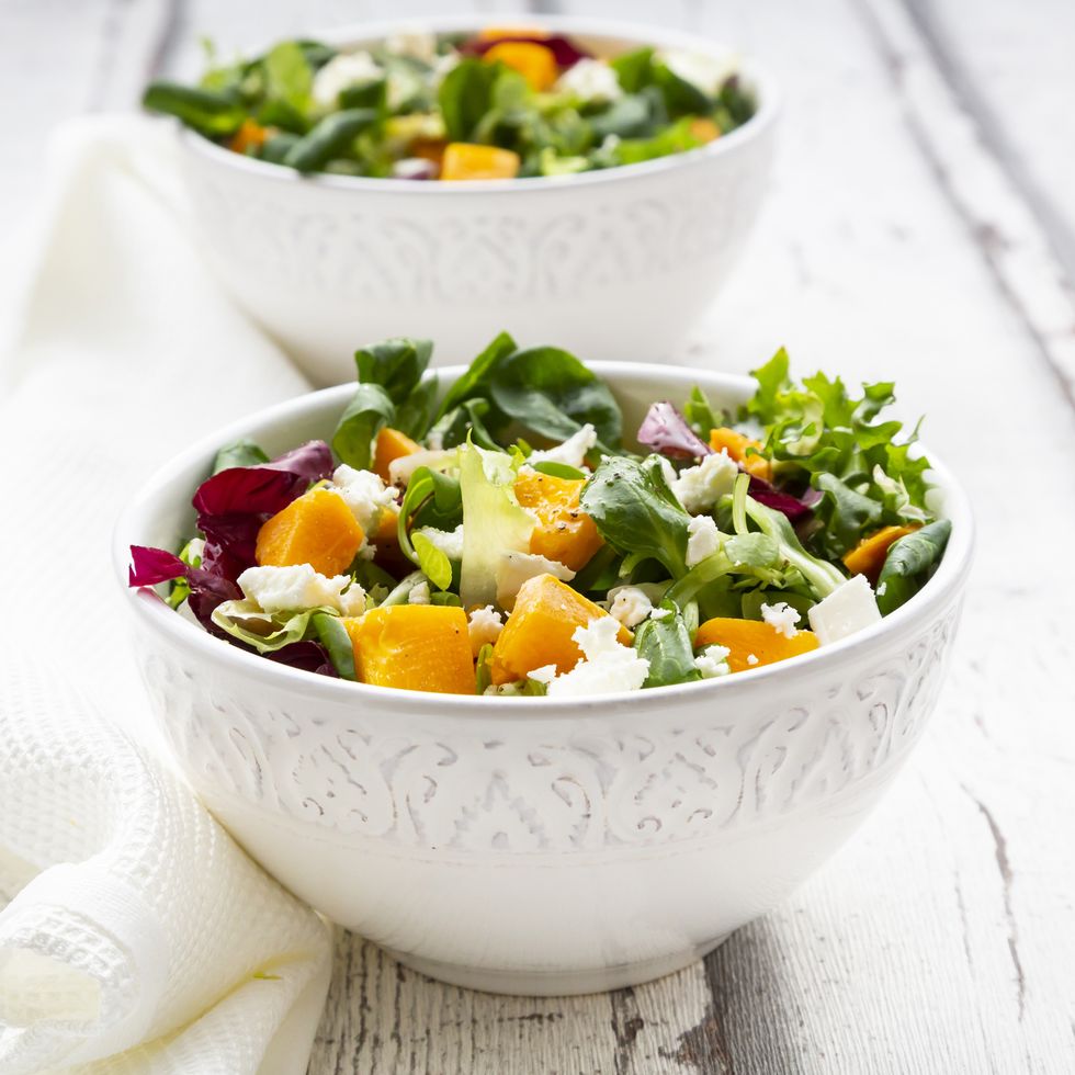 Bowls of autumnal salad with feta and Hokkaido pumpkin