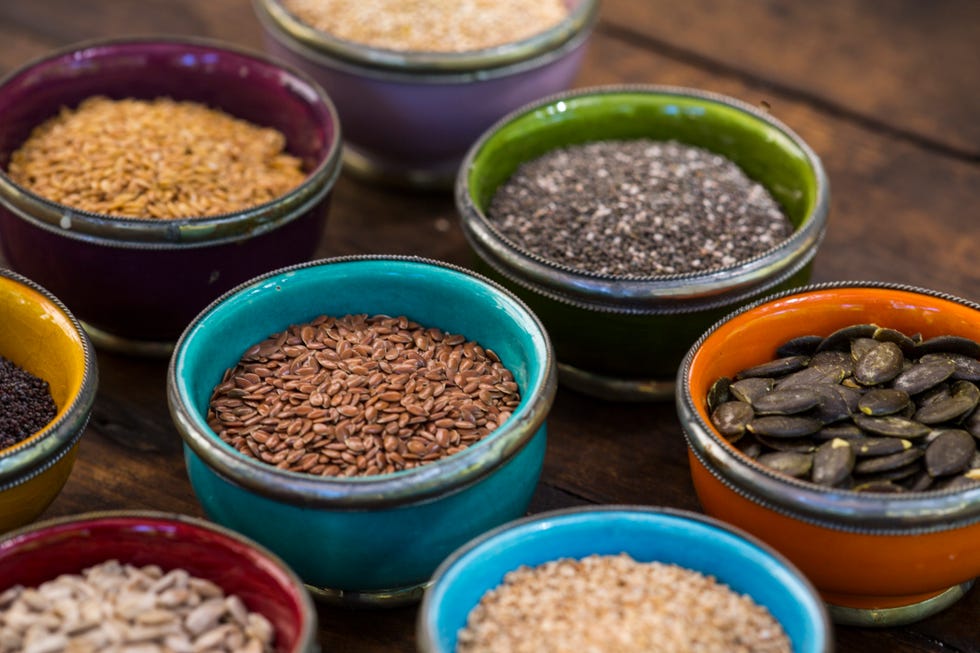 bowls of sunflower, sesame, pumpkin, linseed,chia, flax and nigella seeds