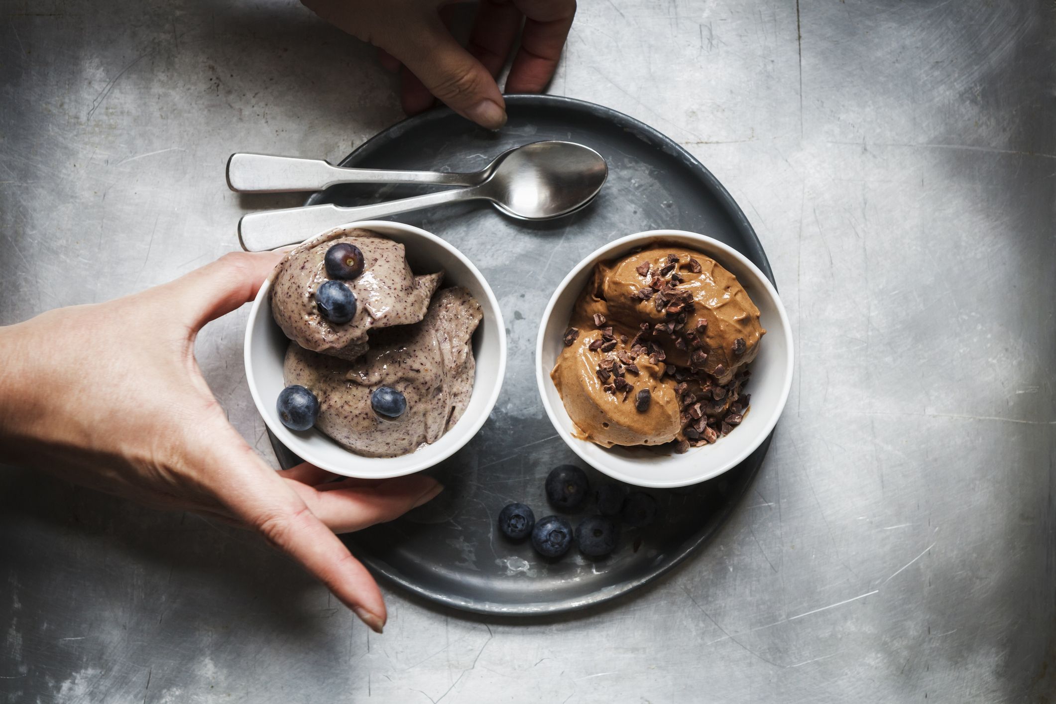 https://hips.hearstapps.com/hmg-prod/images/bowls-of-vegan-blueberry-banana-and-chocolate-royalty-free-image-1690582129.jpg