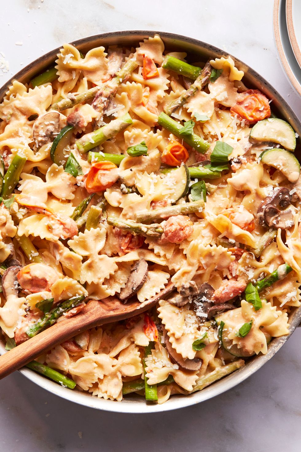 bowtie pasta with asparagus, tomatoes, zucchini and parmesan
