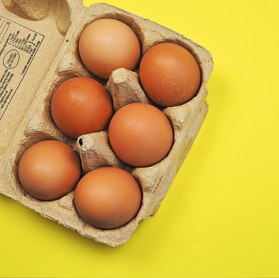 Box of six eggs on a yellow background