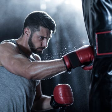 Boxer exercising with punch bag