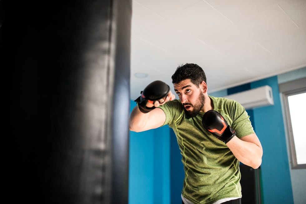 Boxer exercising with punch bag