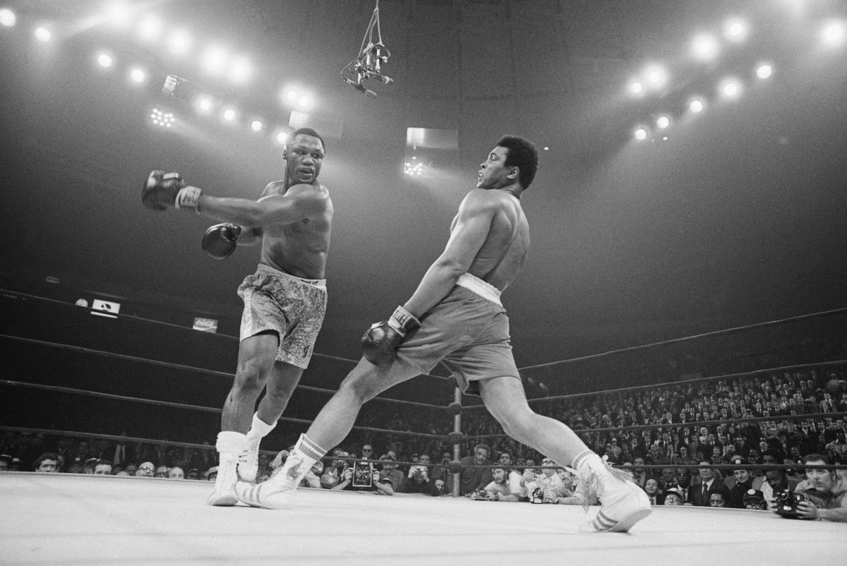 Boxer Muhammad Ali steps away from a punch thrown by boxer Joe Frazier during their heavyweight title fight at Madison Square Garden in 1971
