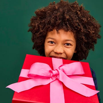 boy holding wrapped red present boy holding wrapped red present