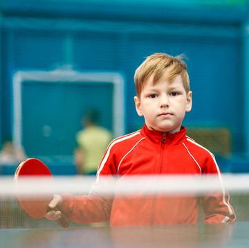 boy in red clothing, playing table tennis
