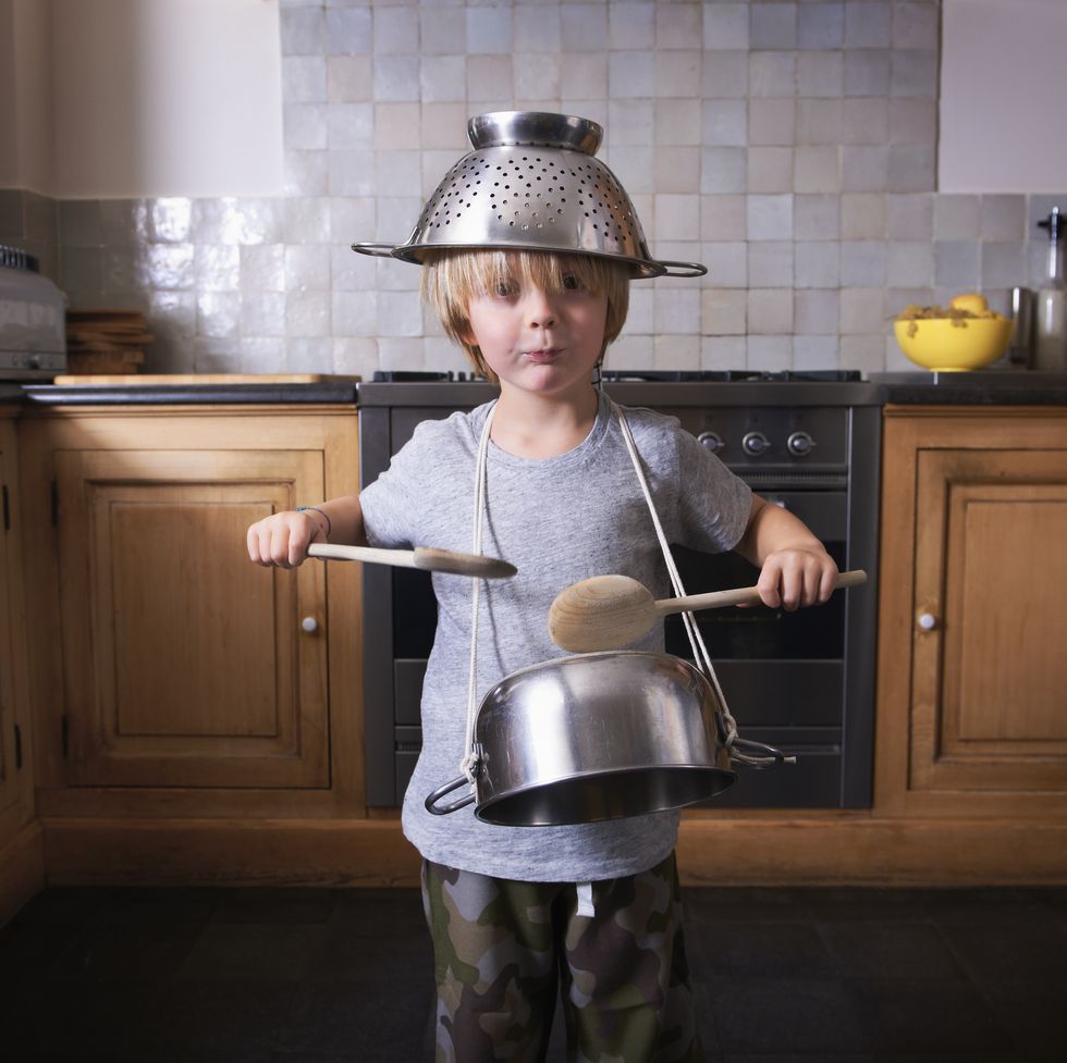 boy playing the drums on a pan with spatulas fun activities for kids