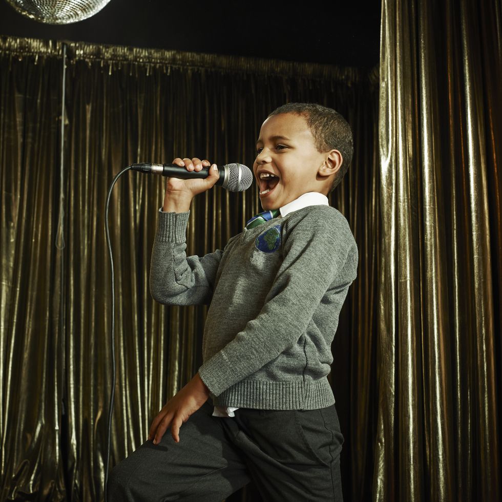 boy singing on stage