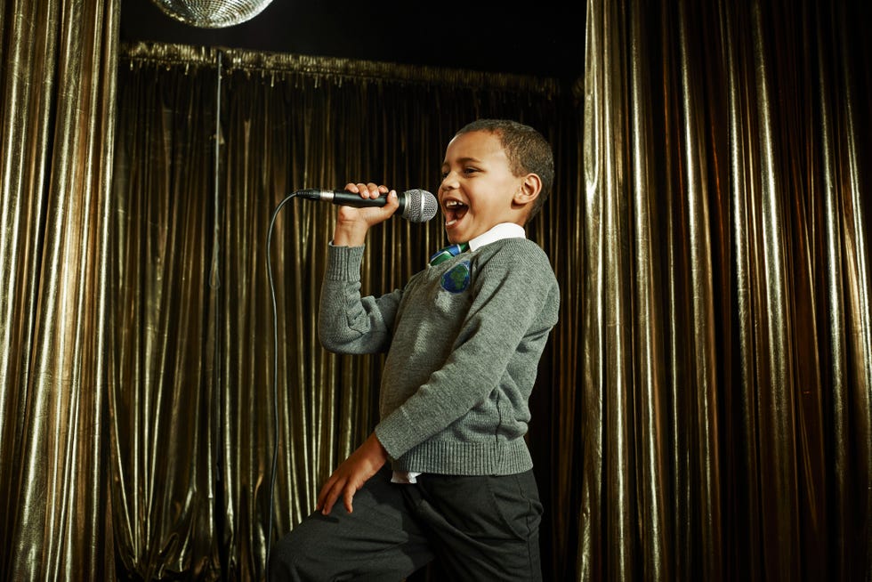 boy singing on stage