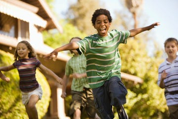 boy with friends and arms outstretched