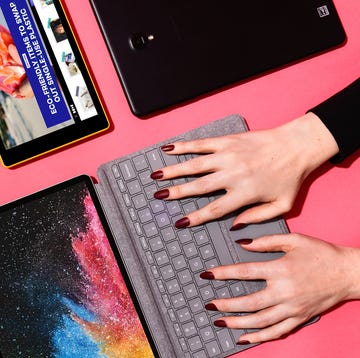 woman typing on tablet keyboard