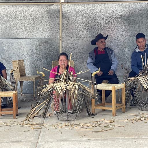 three weavers on benches