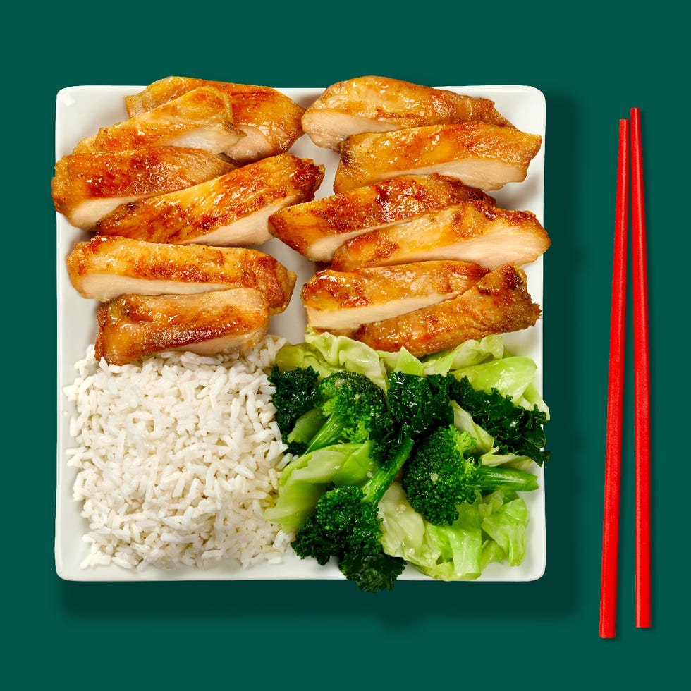 plate of sliced grilled chicken with rice and vegetables