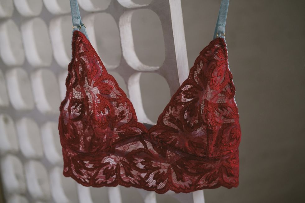 beautiful red lace bodice without bones hanging on a hanger