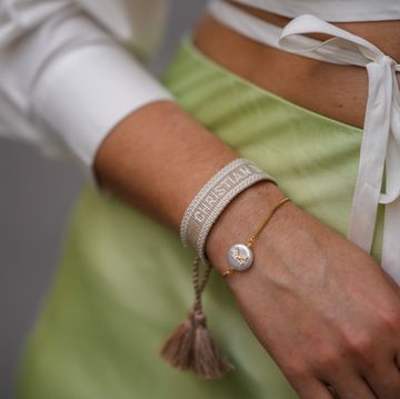 paris, france   june 11 ketevan giorgadze katieone wears a pistachio green flowy lustrous satin midi skirt by ottod’ame, a white cropped shirt with a crossover waist tie by le ger, dior friendship bracelets in pink and cream, on june 11, 2021 in paris, france photo by edward berthelotgetty images