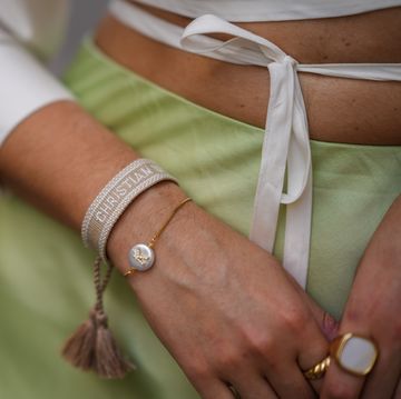 paris, france   june 11 ketevan giorgadze katieone wears a pistachio green flowy lustrous satin midi skirt by ottod’ame, a white cropped shirt with a crossover waist tie by le ger, dior friendship bracelets in pink and cream, on june 11, 2021 in paris, france photo by edward berthelotgetty images