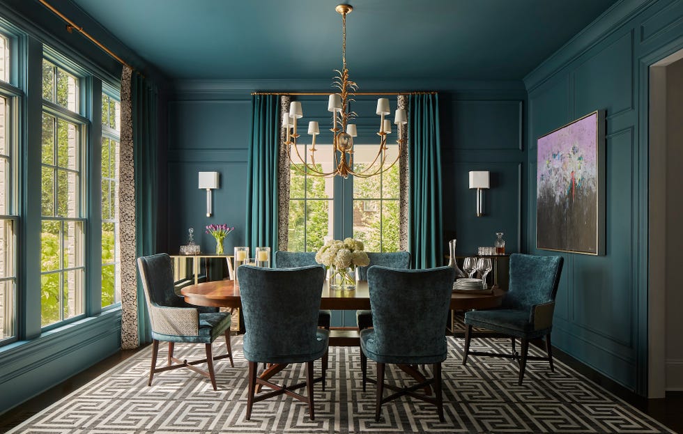 a dining room with a chandelier and chairs