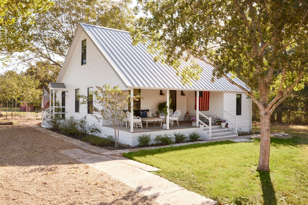 white farmhouse with sloped metal roof