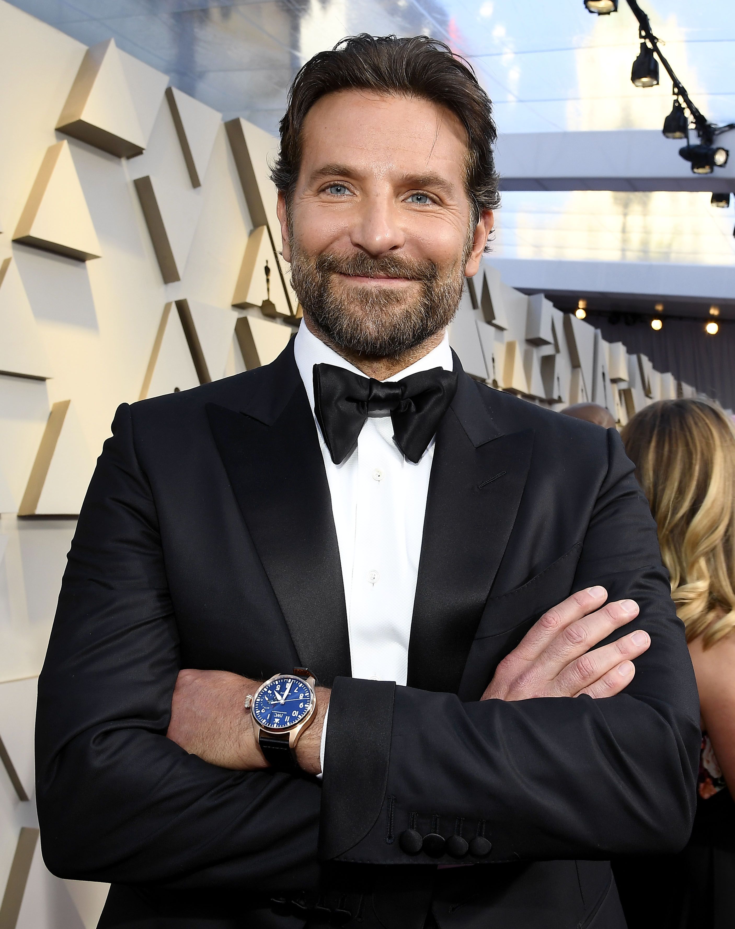 Bradley Cooper cuts a dashing figure in navy suit as he models a $3400 watch