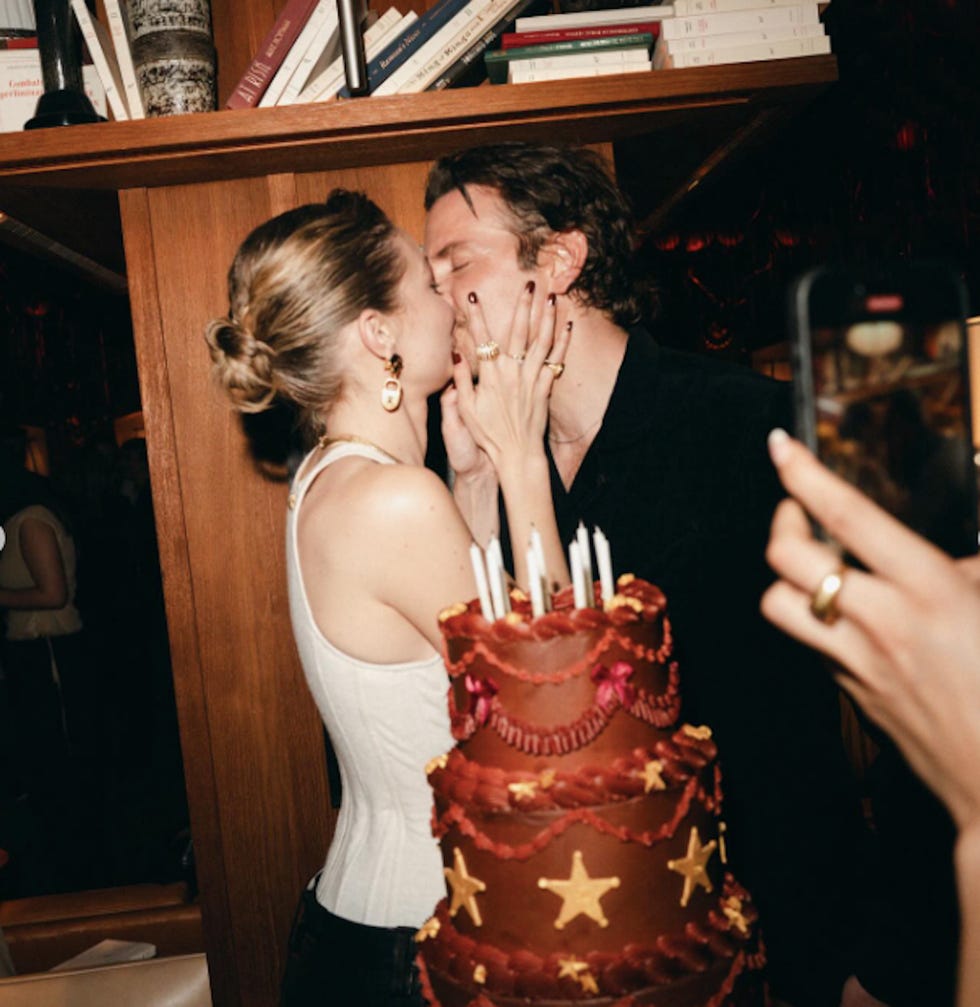 a couple celebrating with a cake and candles