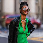 new york, new york   february 12 fashion week guest wearing a black leather coat and a green maxi dress outside patbo during new york city fashion week on february 12, 2022 in new york city photo by jeremy moellergetty images